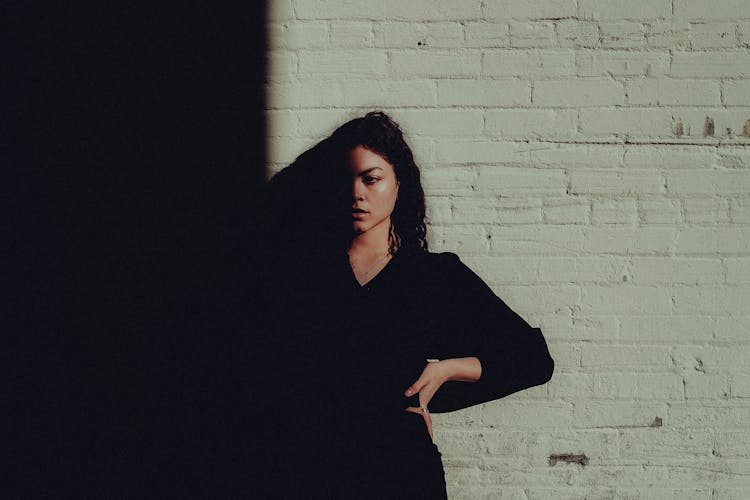 A Woman In Black Long Sleeves Dress