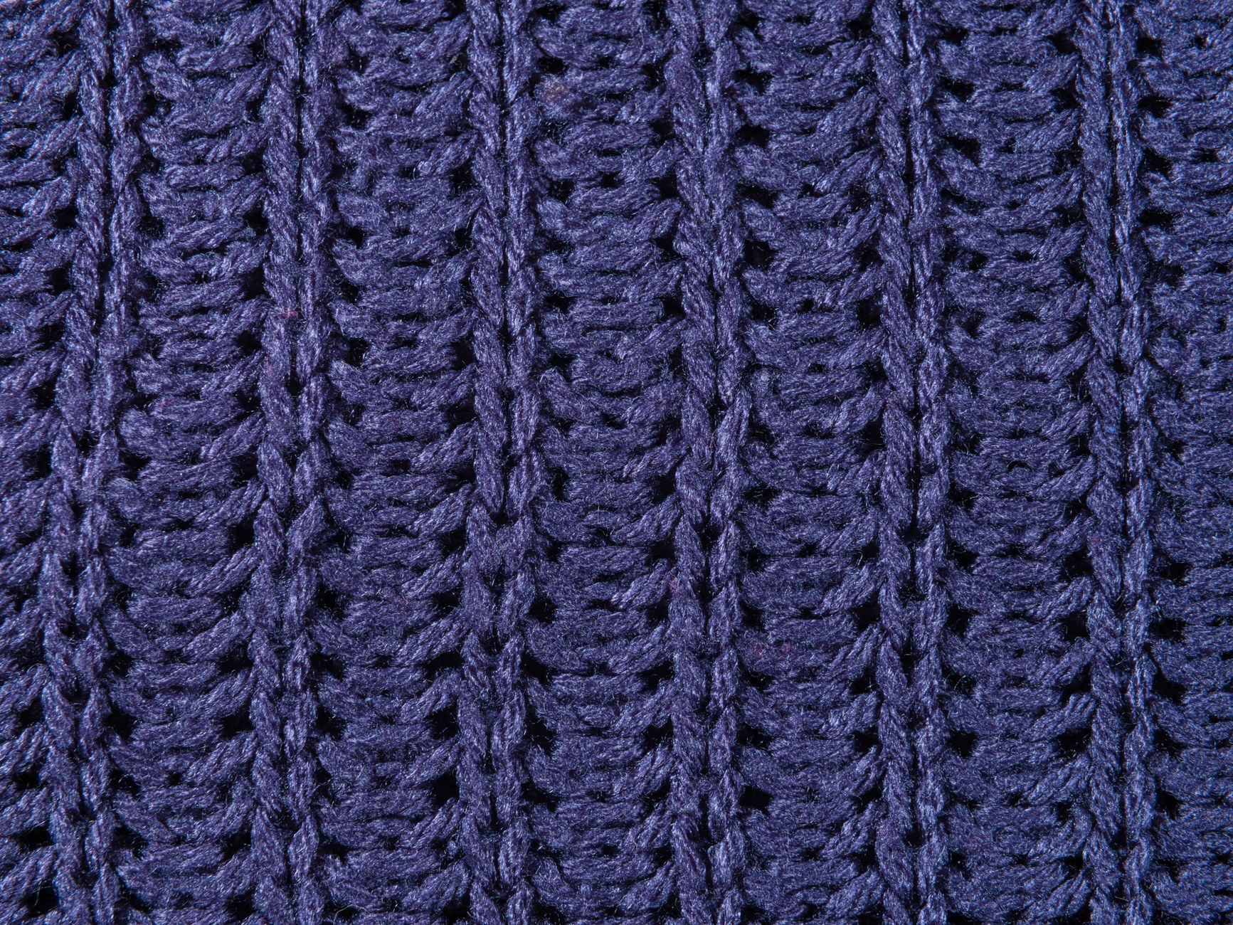 Magnified view of a pilled sweatshirt surface showing small fibre balls tangled on the fabric