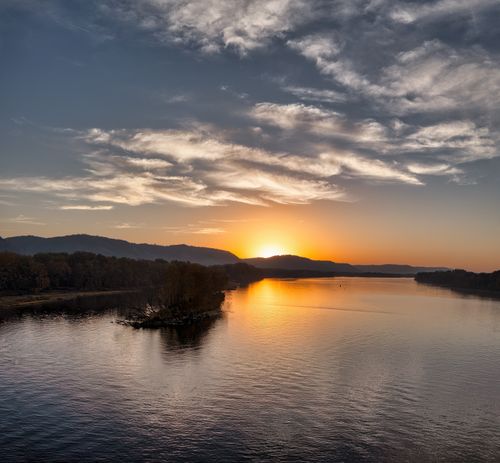Free Stunning sunset over a peaceful lake in West Newton, MN, with vibrant skies. Stock Photo