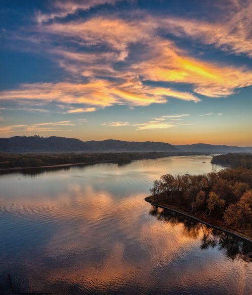 Free Beautiful sunrise over the Mississippi River with stunning reflections and autumn foliage. Stock Photo
