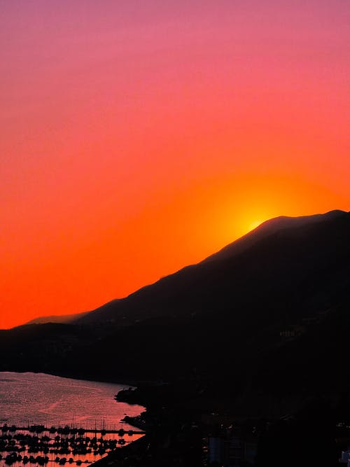 Silhouette of Mountain Under Golden Sky