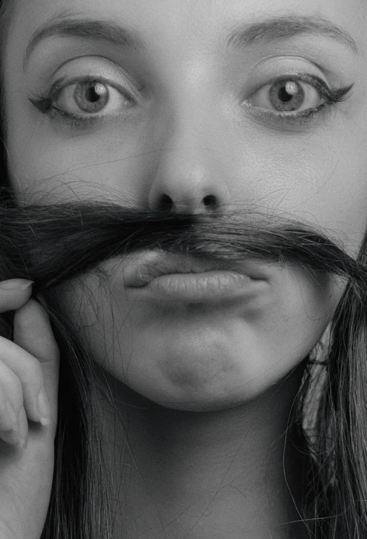 Girl Making Moustache With Hair