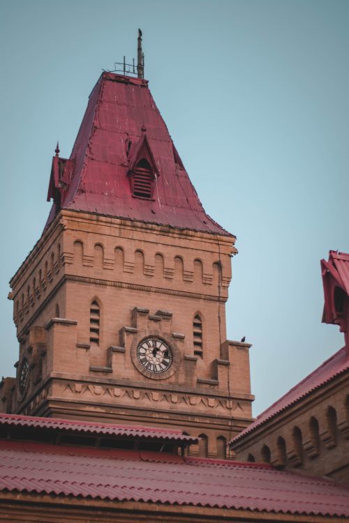 Free Explore the architectural elegance of the Empress Market clock tower in Karachi under a blue sky. Stock Photo