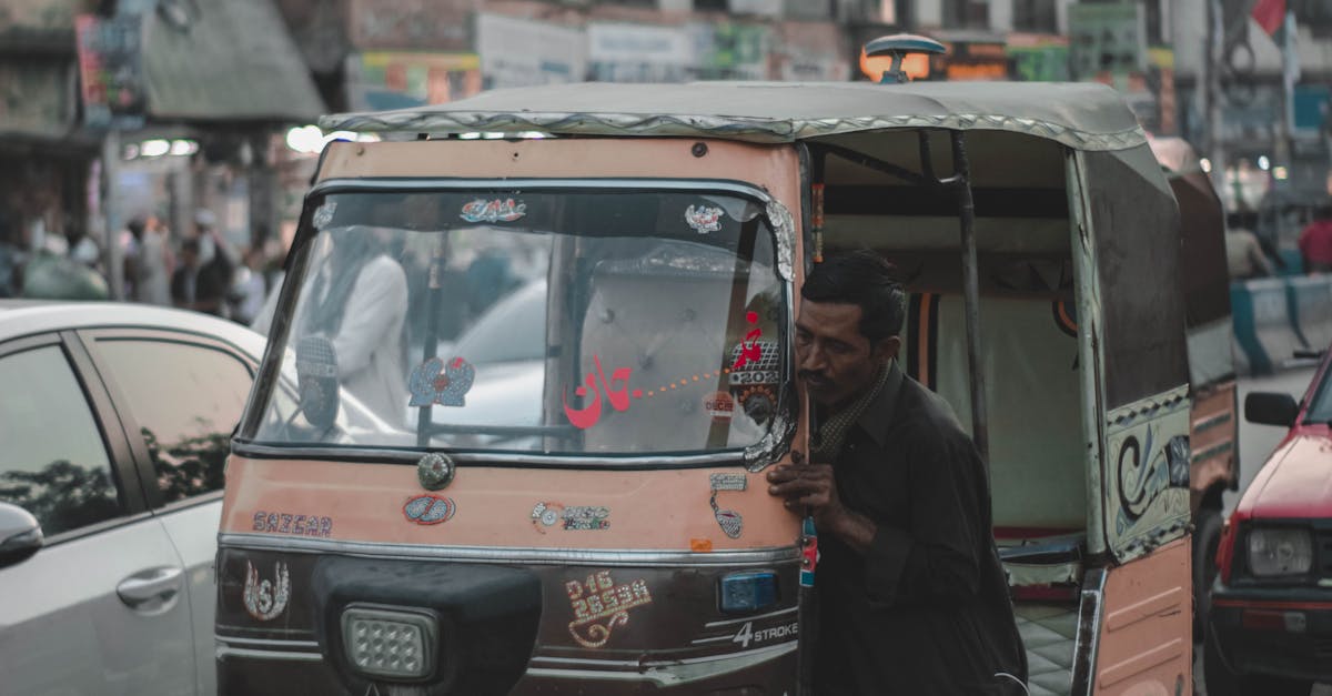 Man Pushing an Auto Rickshaw · Free Stock Photo