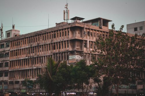 Free A classic urban building with an overcast sky, showcasing industrial architecture and urban life. Stock Photo