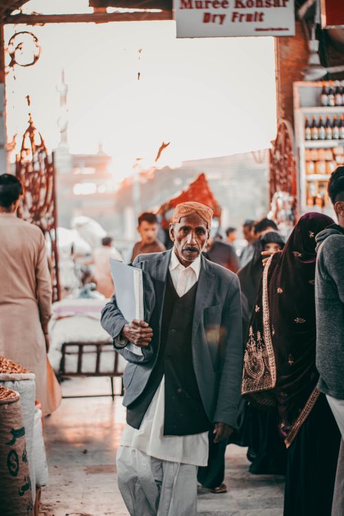 Free A bustling Middle Eastern market street captured at sunset with traditional attire. Stock Photo