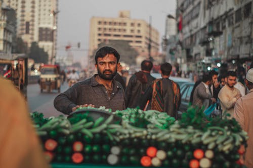Man Selling Vegetables on Street Market