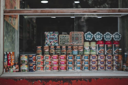 A vibrant selection of canned goods and condiments beautifully arranged in a store window.