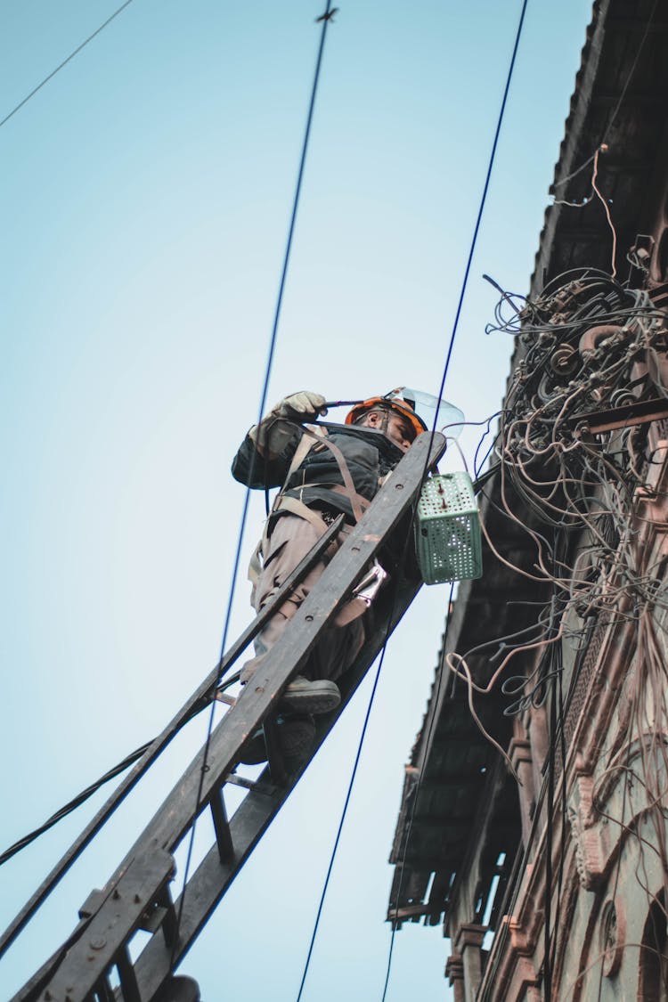 Man On Top Of A Ladder