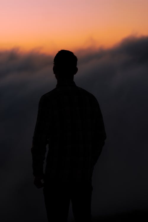 Free adult man pose during sunset in silhouette Stock Photo