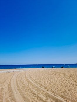 Experience the tranquil beauty of Tekirova's pristine beach with azure skies and golden sands.