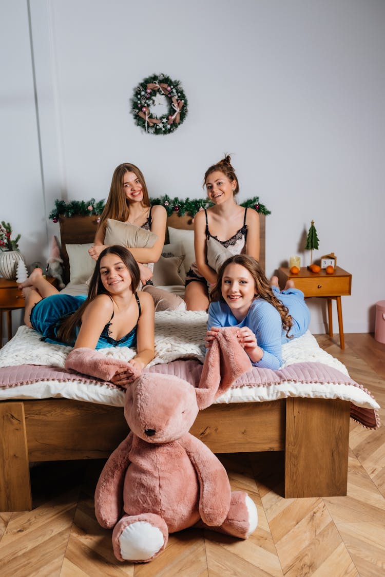 Women Posing On Bed