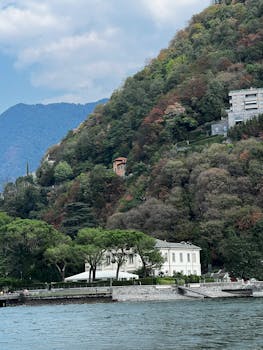 Discover the picturesque landscape of Lake Como, surrounded by lush hills and charming buildings.