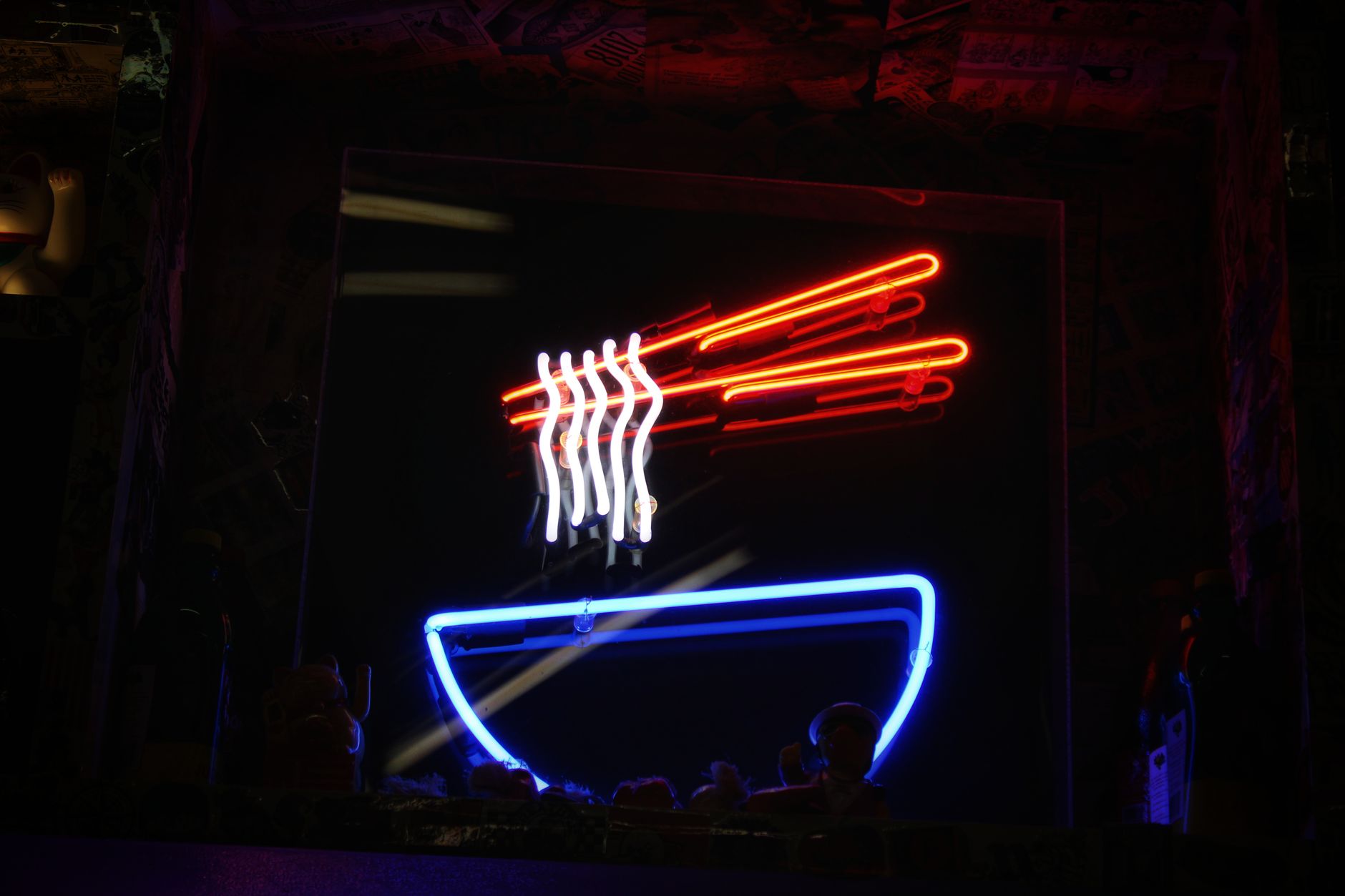 Bright neon noodle sign illuminating a restaurant in Las Vegas, capturing the lively nightlife.