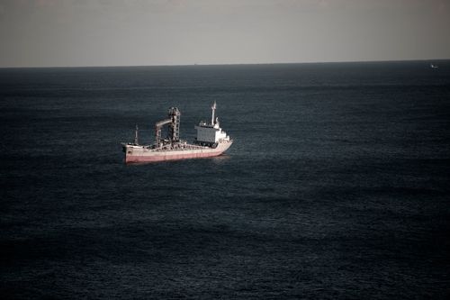 Free Cargo ship navigating in the tranquil waters off the coast of Donghae-si, South Korea. Stock Photo