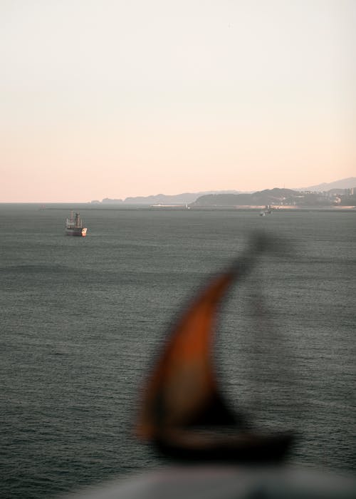 Vessel and Sea behind Shore