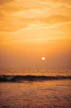 A mesmerizing view of the golden sunset casting reflections on the ocean waves.