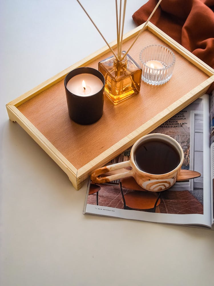 Wax Candles On Tray Near Coffee Cup