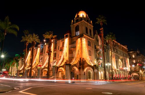 Free A stunning view of Mission Inn Riverside at night, beautifully illuminated with festive lights. Stock Photo