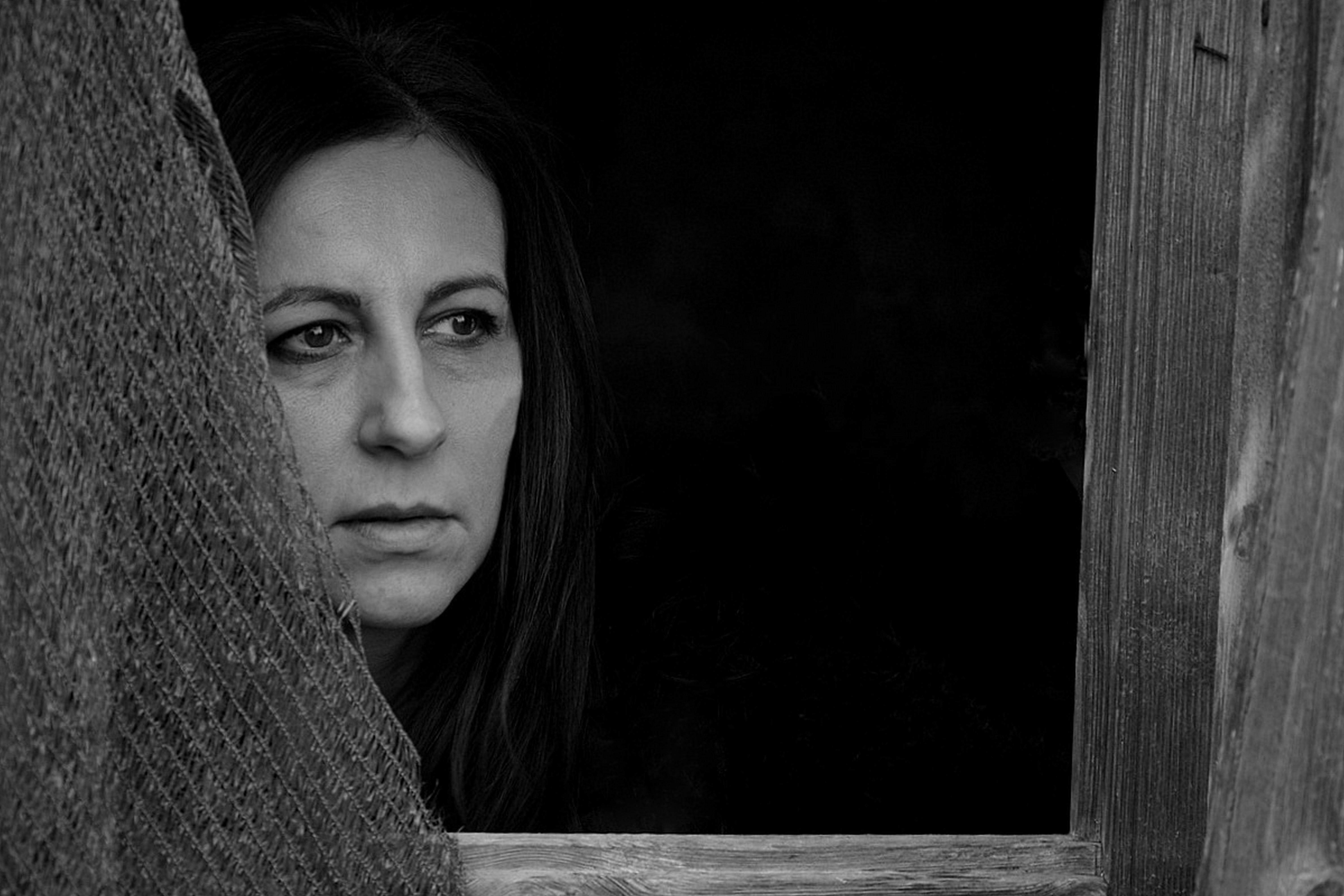 Woman Face in Window Opening in Black and White · Free Stock Photo