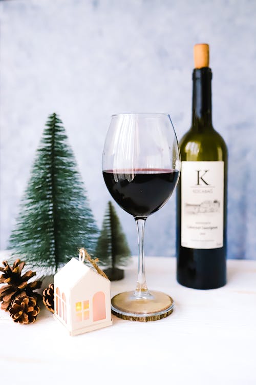 Red Wine in Glass and Christmas Decor on Table