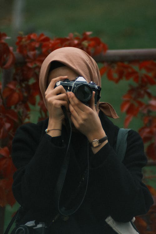 Woman Wearing a Headscarf Taking a Picture
