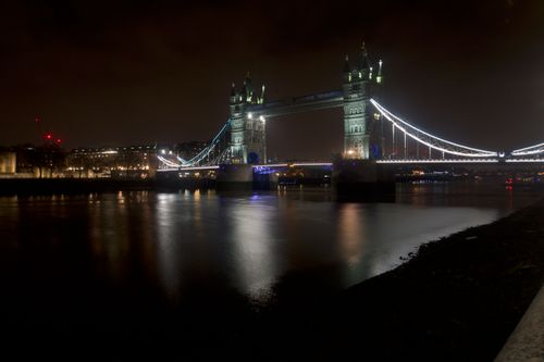 Free Illuminated Tower Bridge at night over the Thames in London, a renowned UK landmark. Stock Photo