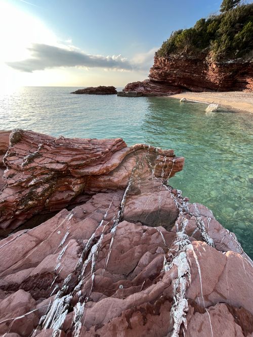 Free Capture the beauty of Montenegro's coastline with red rocks and clear turquoise sea. Stock Photo