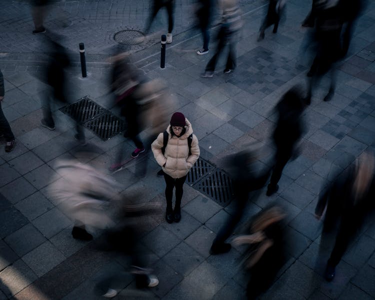 Woman Standing Alone In Crowd