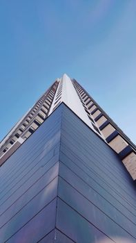 Low angle view of a modern skyscraper with clear blue sky in Bucaramanga, Colombia.