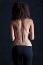 Topless Woman Standing Facing the Wall