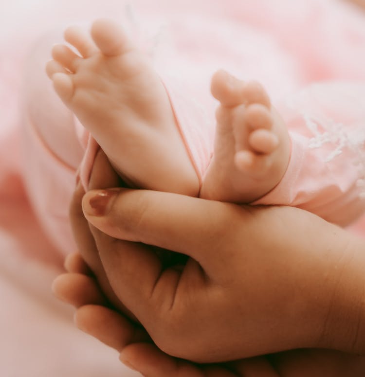 Hand Touching Baby Feet