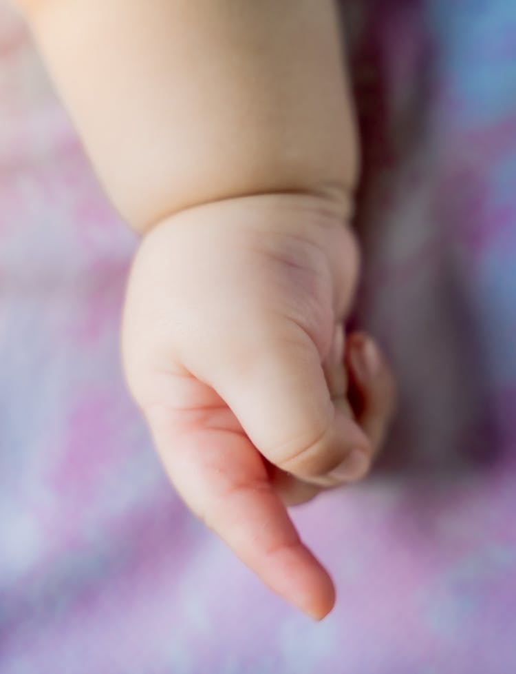 Close Up Photo Of Newborn Baby's Hand With Finger Pointing