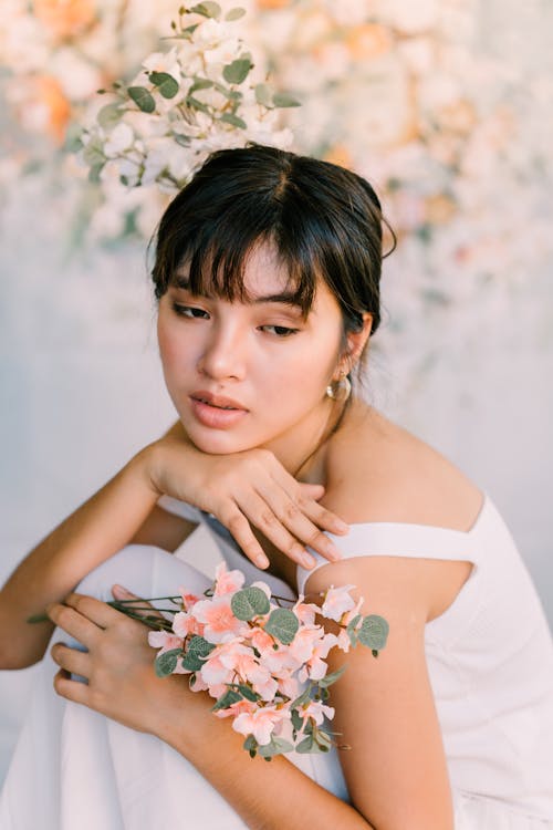 Woman Sitting with Flowers