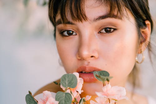 Beautiful Young Woman Holding Flowers