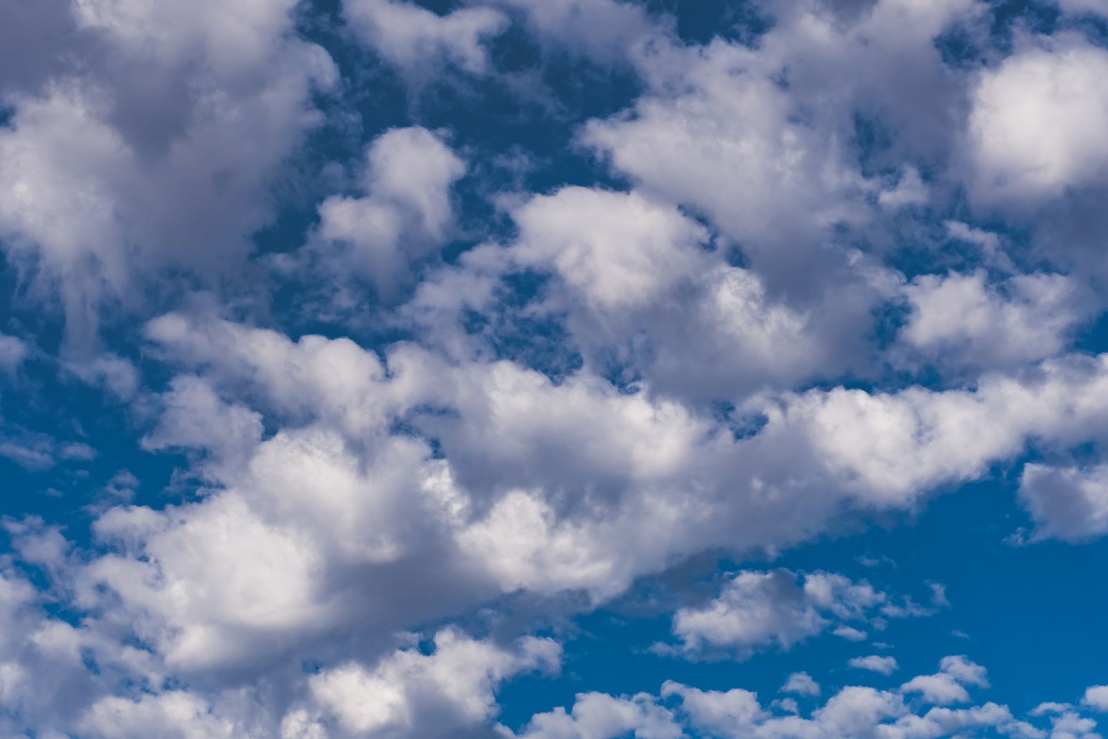 Open blue sky with soft cumulus clouds — photo by Brett Sayles on Pexels