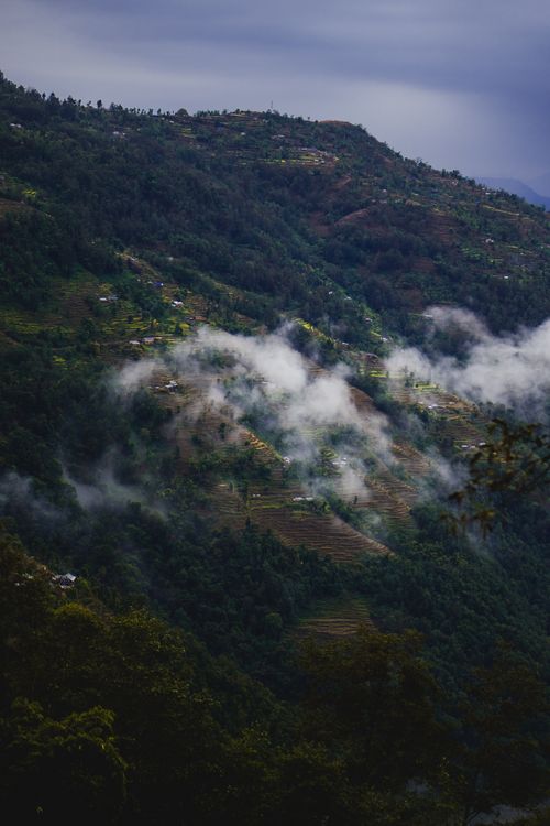 Free Serene view of misty hills and terraced fields in Kathmandu Valley, Nepal, captured on a cloudy day. Stock Photo