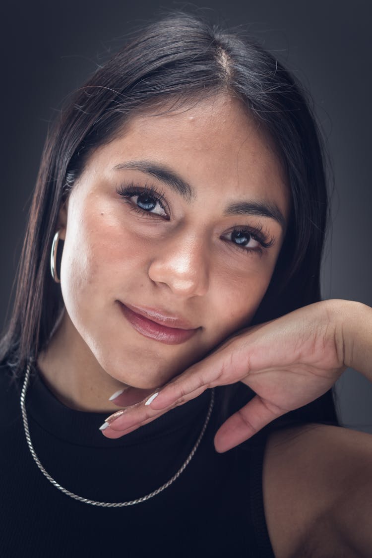 Portrait Of A Woman Leaning Her Face Against Her Hand