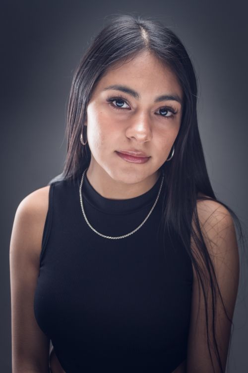 Free Studio portrait of a young woman with long black hair and necklace, highlighting elegance and grace. Stock Photo
