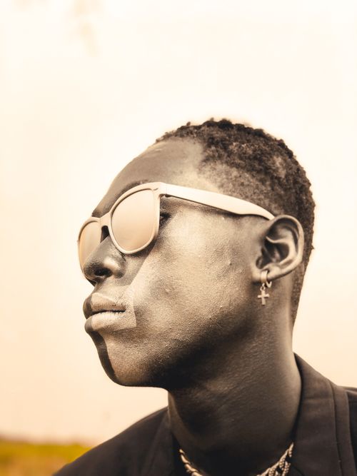 Free Artistic portrait of a young man in sunglasses with a thoughtful expression. Stock Photo
