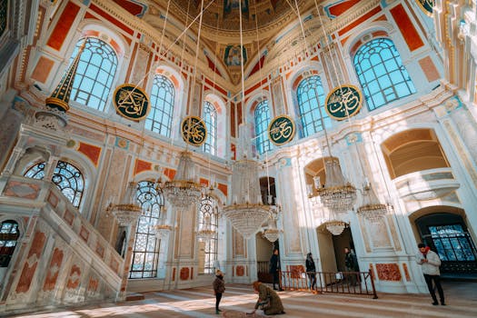 Explore the luxurious chandeliers and ornate architecture in this beautiful mosque interior.