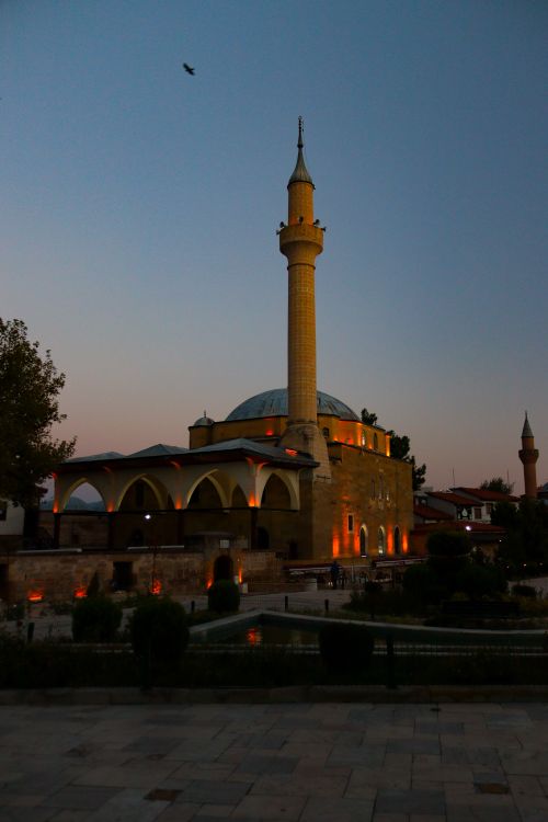 Free Serene evening view of Merzifonlu Kara Mustafa Pasha Mosque with illuminated minaret in Merzifon, Turkey. Stock Photo