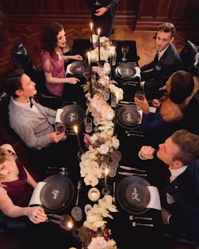 Overhead view of friends enjoying a formal dinner with elegant decor.