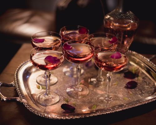Free Chic cocktails elegantly presented with rose petals on a vintage silver tray. Stock Photo