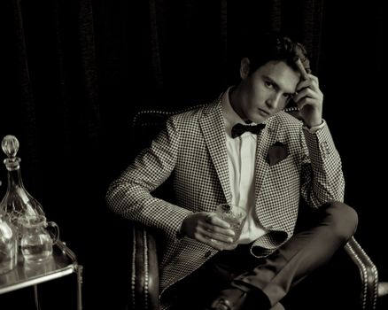 A man in a suit sitting on a chair
