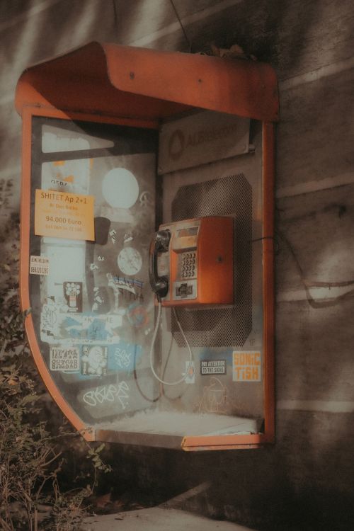 Free A vintage public payphone on the streets of Tirana, captured in a moody, nostalgic tone. Stock Photo