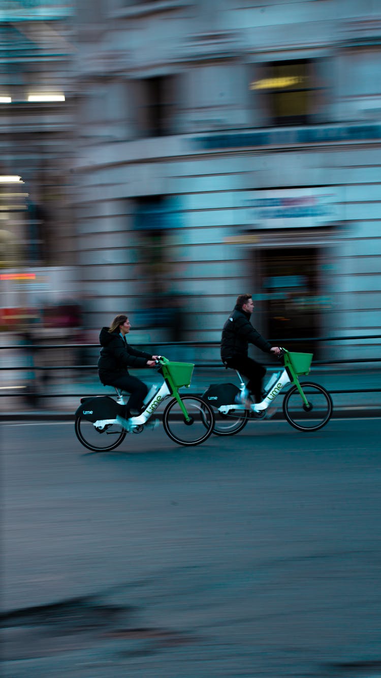 Woman In Black Jacket Riding Green And White Bicycles