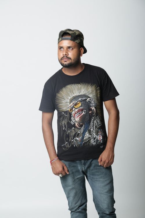 Free Bearded man in casual wear and cap posing in a studio. Stock Photo