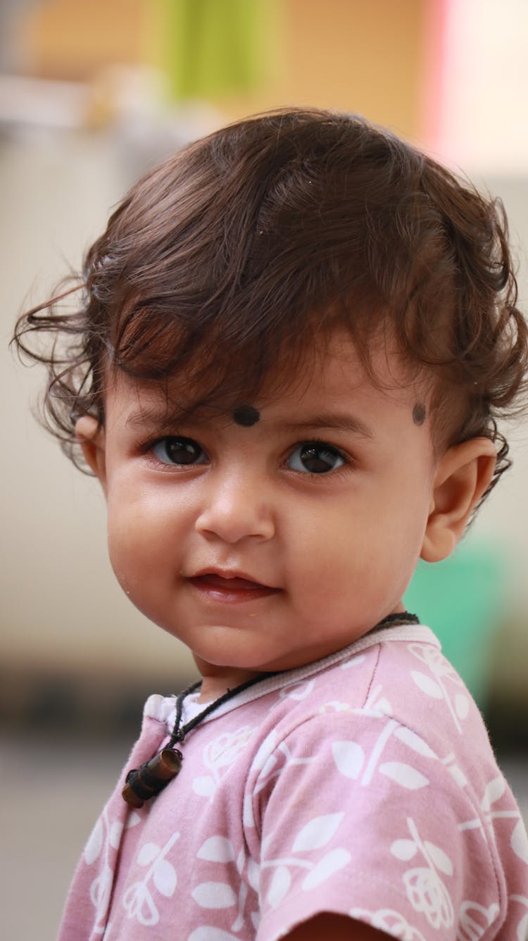 A Baby Wearing Pink Shirt 