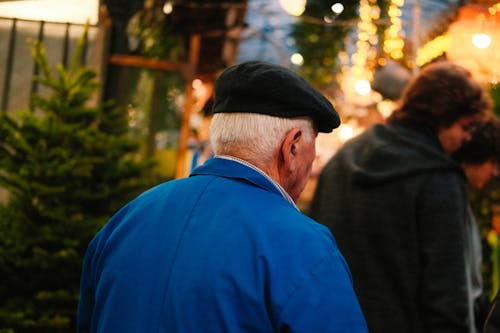 Man in Hat near Christmas Tree